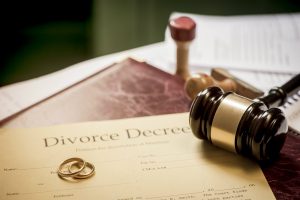 Divorce decree with gavel and rings